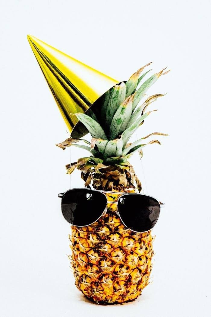 why-choose-us A pineapple dressed in sunglasses and a party hat, exuding a fun and tropical vibe.